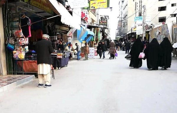 Residents of the Sayyida Zainab area of southern Damascus are seen here in a photo taken in May. The area, controlled by Iran-aligned militias, has seen an increase in the illegal drug trade, residents say. [Ahmed Obeid/ Sawt al-Asima]