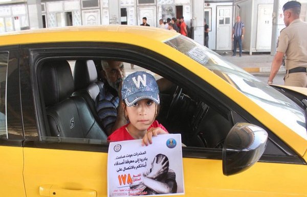 An Iraqi girl holds a sign that warns of the dangers of drugs on May 19 as part of an awareness campaign carried out by Iraqi forces in conjunction with their efforts to take down regional and international drug smuggling networks. [Iraqi Ministry of Interior/Directorate of Narcotics and Psychotropic Substances Control]