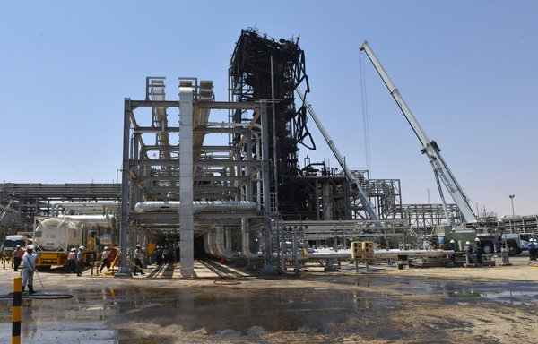 Employes of Aramco oil company stand near a heavily damaged installation in Saudi Arabia's Khurais oil processing plant on September 20, 2019. This Iran-backed attack forced China to pay an additional $97 million per day as Brent crude prices rose to their highest level on record. [Fayez Nureldine/AFP]