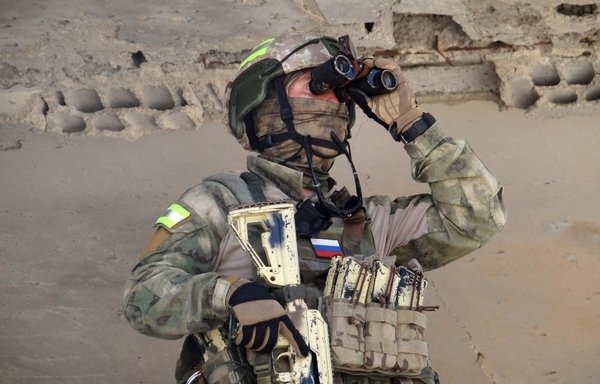 A Russian soldier uses binoculars during a patrol in Daraa province's Daraa al-Balad district on September 1. [Sam Hariri/AFP]
