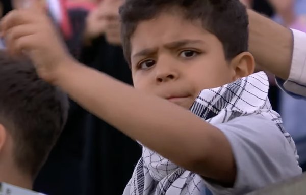 الأطفال هم هدف أغنية جديدة مؤيدة لخامنئي اُنتقدت كمحاولة للتلقين العقائدي. طفل يشاهد هنا في حفل غنائي في مجمع أزادي الرياضي بطهران في شهر أيار/مايو. [لقطة شاشة من IRIB]