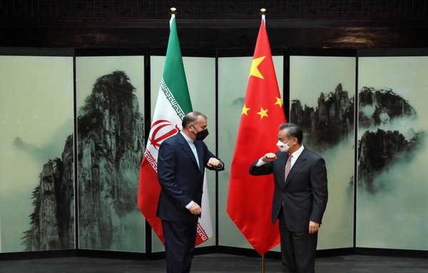 Chinese foreign minister Wang Yi and his Iranian counterpart Hossein Amir-Abdollahian bump elbows during their March 31 meeting in Beijing. [Chinese foreign ministry website]