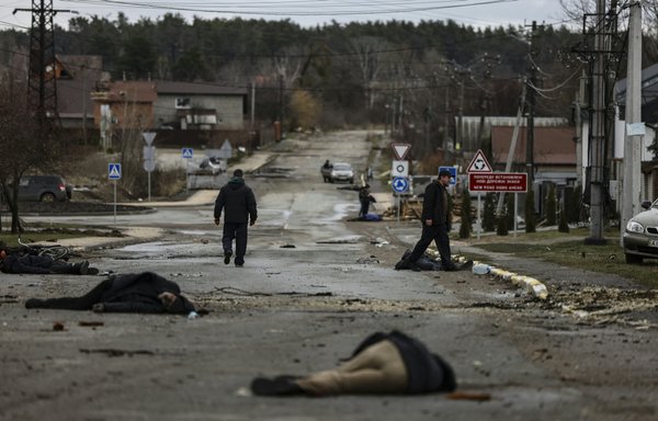 In this photo taken on April 2, bodies of Ukrainian civilians lie in Bucha, northwest of Kyiv, after the Russian army pulled back from the city. Radio traffic intercepted by German intelligence suggests member of the Wagner Group played a role in the atrocities. [Ronaldo Schemidt/AFP]