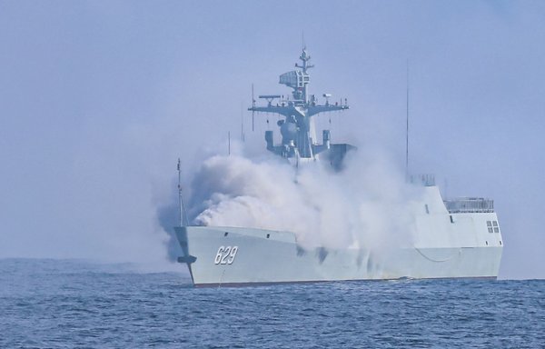 A Chinese frigate deploys smoke to take cover during drills in the South China Sea in April. [Chinese Ministry of Defence]