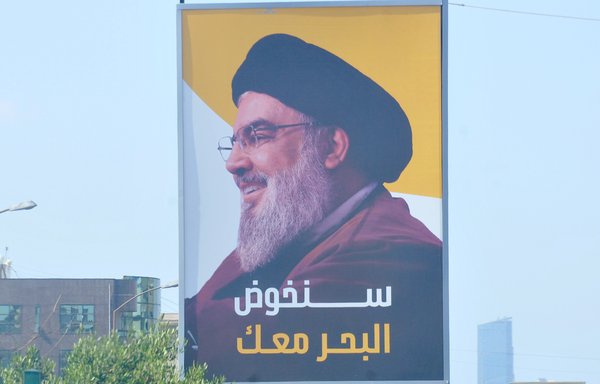 A photo of Hizbullah chief Hassan Nassrallah reads 'We will go to the sea with you' on Beirut's Airport Road. [Ziad Hatem/Al-Mashareq]