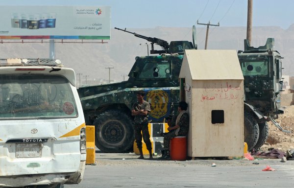 Pro-government forces in Yemen man a checkpoint in the Shabwa provincial capital of Ataq on January 20. Shabwa has seen a heightened al-Qaeda presence in recent weeks. [Saleh al-Obeidi/AFP]