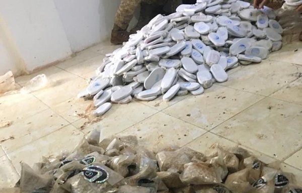 Jordanian authorities display hashish and Captagon pills seized April 19, 2021, as smugglers tried to infiltrate from Syria. [Jordanian Armed Forces Facebook page]