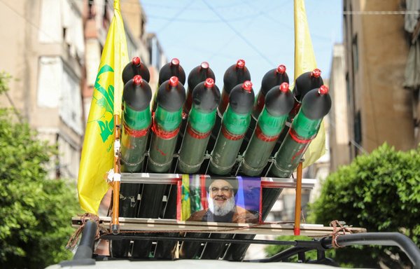 A Hizbullah supporter drives around with a mock rocket launcher in Beirut, on May 15, as voters cast their ballots in the parliamentary election. [Ibrahim Amro/AFP]
