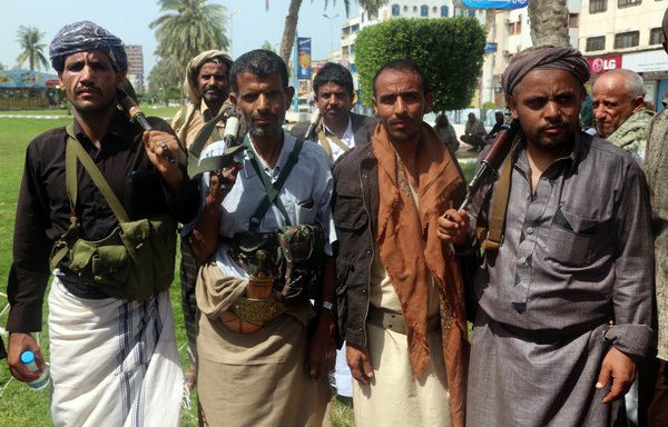 Armed Houthi fighters attend a gathering to mobilise more fighters to the battlefront in the Red Sea port city of al-Hodeidah on June 18, 2018. [Abdo Hyder/AFP]