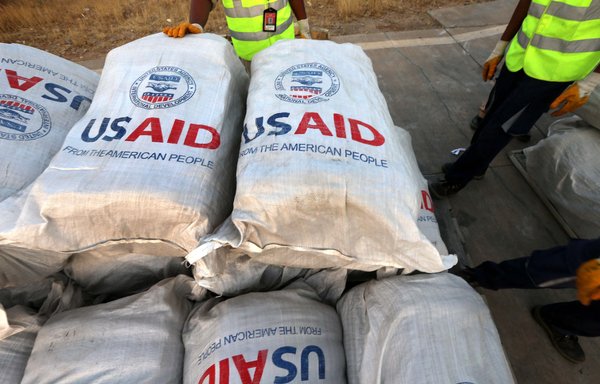 Airport personnel check humanitarian aid supplies after 60 tonnes of aid from USAID was unloaded from a plane at the airport in Erbil in northern Iraq's Kurdish region, on September 2, 2014. [Safin Hamed/AFP]