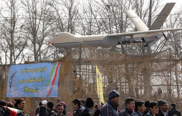 Iranians walk past Iran's Shahed-129 drone during celebrations in Tehran February 11, 2016, to mark the 37th anniversary of the Islamic revolution. [Atta Kenare/AFP]