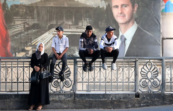 Syrians await the release of relatives held in regime prisons in May in Damascus. [Louai Beshara/AFP]