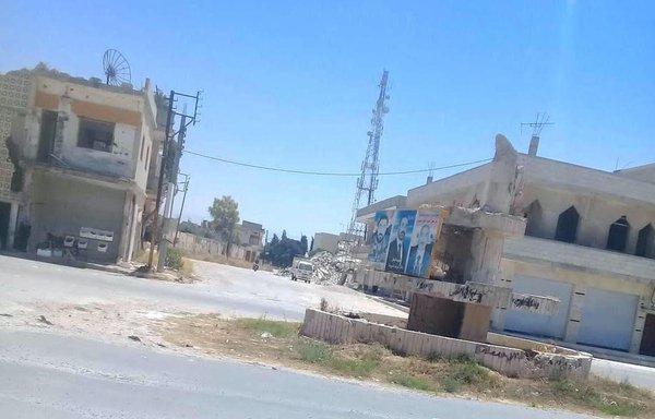 Posters of Hizbullah leaders and fighters killed in battle are plastered throughout the bullet-scarred neighbourhoods of al-Qusayr. [Hadi al-Abdullah]