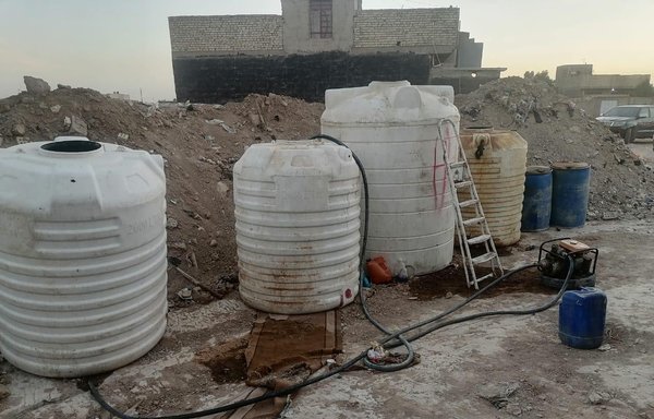 Iraqi authorities display containers they seized that had been used for storing smuggled fuel in southern Baghdad on July 13. [Iraqi Ministry of Defence]