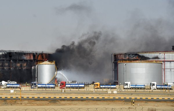 Firefighters extinguish the last embers at a Saudi Aramco oil facility in the Red Sea port city of Jeddah on March 26, a day after the Houthis attacked the facility with drones and missiles. [AFP]