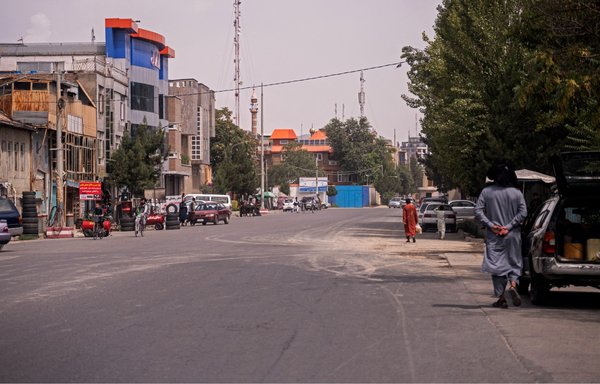 People walk along a road in the Sherpur neighbourhood of Kabul on August 2. US President Joe Biden announced on August 1 that al-Qaeda chief Ayman al-Zawahiri had been killed by a drone strike in the Afghan capital. [Wakil Kohsar/AFP]