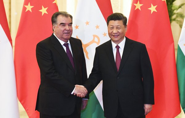Chinese President Xi Jinping (right) shakes hands with Tajik President Emomali Rahmon before their meeting in Beijing on April 28, 2019. [Madoka Ikegami/AFP]