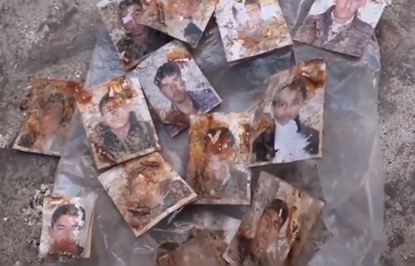 Photos found in the Manbij mass grave, seen here in a screenshot from a video posted online on July 27, likely belonged to the victims. [Manbij al-Hadath Channel/Telegram]