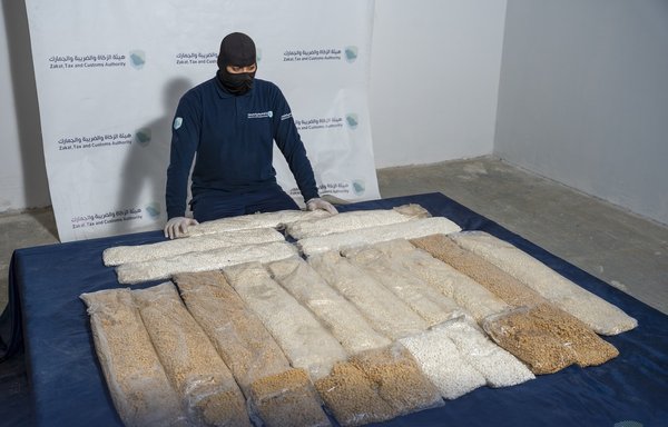 A Saudi Zakat, Tax and Customs Authority officer displays a shipment of Captagon pills seized before they entered the kingdom on February 2. [Zakat, Tax and Customs Authority website]