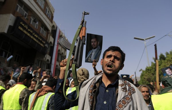 Supporters of the Iran-backed Houthis brandish their weapons and raise portraits of their leader Abdul Malik Al-Houthi in a rally in Sanaa on June 3, a day after Yemen's warring parties agreed to renew a two-month truce. [Mohammed Huwais/AFP]