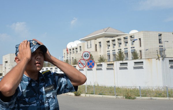 A Kyrgyz police officer patrols next to the Chinese embassy in Bishkek, Kyrgyzstan, on August 30, 2016. The OSCE has found evidence of a Chinese campaign to compromise the Kyrgyz news media. [Vyacheslav Oseledko/AFP]