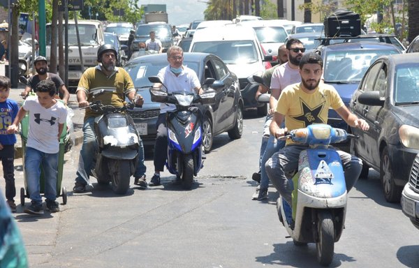 A boy wheels a garbage bin down a street in Beirut, where observers say child labour has grown to scandalous proportions. [Ziad Hatem/ al-Mashareq]