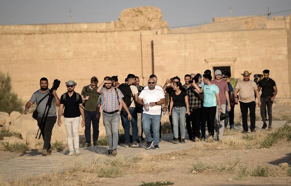 A group of tourists visit the ancient city of Hatra in northern Iraq on September 10, as local authority initiatives seek to encourage tourism and turn the page on the years of ISIS violence. [Zaid al-Obeidi/AFP]