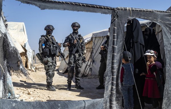 Kurdish security forces inspect tents in al-Hol camp in northeastern Syria on August 28 during a security sweep. [Delil Souleiman/AFP]