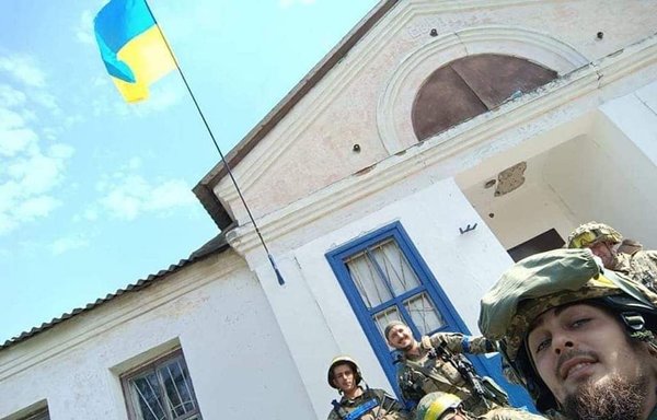 Ukrainian troops take a selfie with a Ukrainian flag after liberating a town in Kharkiv province from Russian forces in this photo posted on September 10. [Ukrainian General Staff/Twitter]