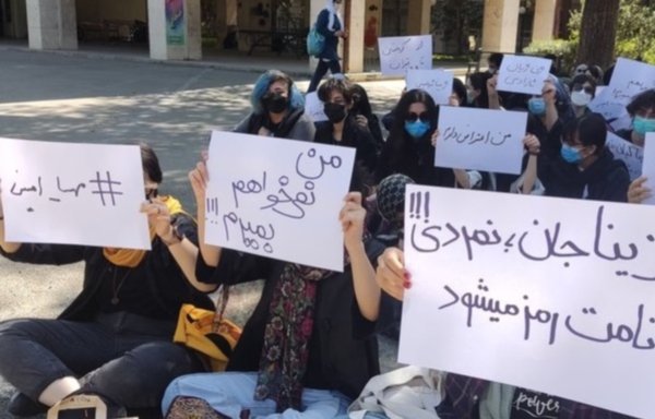 A group of university students gathered in protest in Tehran in the days after Mahsa Amini's death on September 16, holding signs saying 'I don't want to die' and 'You haven't died; your name will become a symbol', the Farsi translation of the sign on Amini's burial site. [Social media]