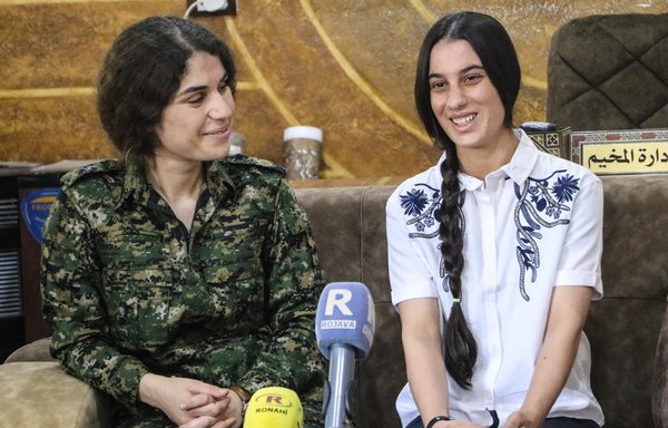 Wafa Ali Abbas, a member of the Yazidi minority seen here with a Kurdish security official on September 12, was freed from ISIS elements in al-Hol during an ongoing security campaign. [Facebook page of Syrian journalist Alaa Hasso]