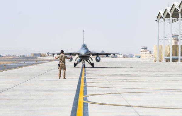 A member of the US Air Force marshals an F-16 fighter jet at King Faisal air base, Saudi Arabia, in support of Operation Agile Spartan II on March 10. [CENTCOM]