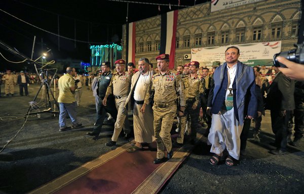 Houthi 'defence minister' Muhammad Nasser al-Atifi (centre) attends a parade commemorating the 8th anniversary of the group's takeover of Sanaa, on September 20. [Mohammed Huwais/AFP]