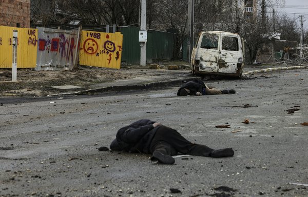 Dead bodies lie on a street in Bucha, Ukraine, on April 2. The bodies of dozens of civilians were found lying on a single street after Ukrainian forces retook Bucha from Russian troops. Intercepted communications put Wagner Group mercenaries at the scene of the crime. [Ronaldo Schemidt/AFP]