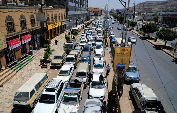 Vehicles queue at a petrol station in Sanaa on March 14, amid fuel shortages in the war-torn country. [Mohammed Huwais/AFP]