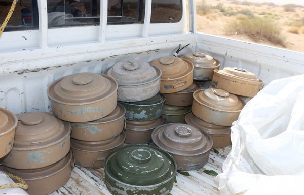 Defused land mines, reportedly planted by the Houthis, are stacked in the back of a truck as pro-government forces clear an area on the outskirts of Bayhan in Shabwa province, Yemen, on January 19. [Saleh al-Obeidi/AFP]