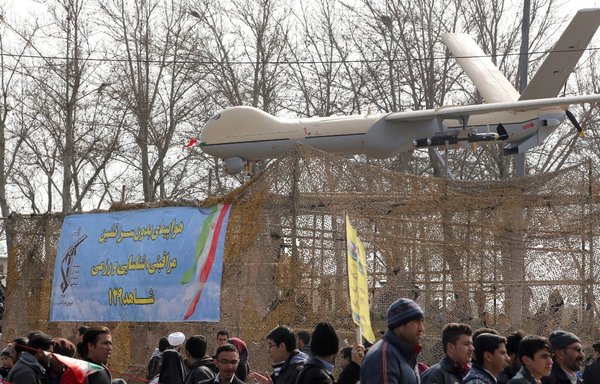 Iranians walk past Iran's Shahed-129 drone during celebrations in Tehran to mark the 37th anniversary of the Islamic revolution on February 11, 2016. [Atta Kenare/AFP]