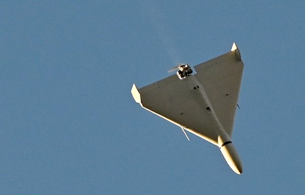 A drone flies over Kyiv during an attack on October 17, amid the Russian invasion of Ukraine. Ukraine officials said Kyiv had been struck four times in an early morning Russian attack with Iranian drones that damaged a residential building and targeted the central train station. [Sergei Supinsky/AFP]