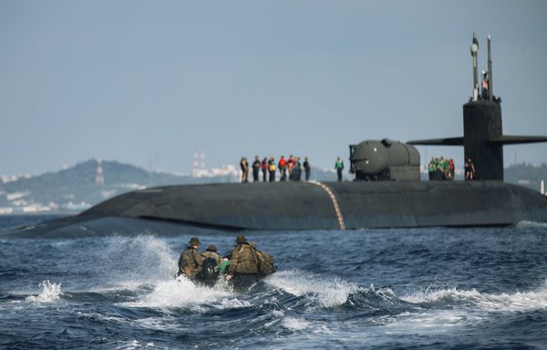 Marines utilise combat rubber raiding crafts to approach the guided missile submarine USS Ohio during an integration exercise off the coast of Okinawa, Japan, February 2, 2021. [US Department of Defence]