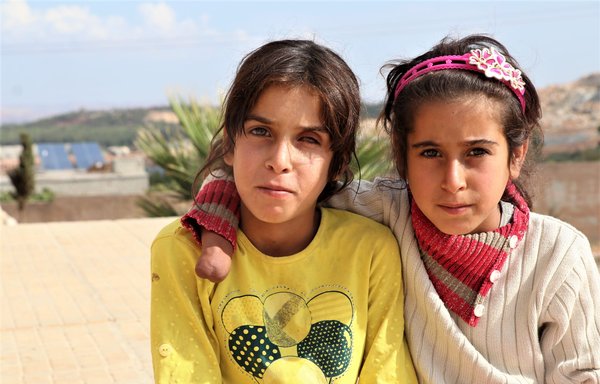 These two sisters were disabled by injuries they sustained when a Russian cluster bomb was dropped on the outskirts of Idlib city. They lost their father last year in an explosion caused by a war remnant. [White Helmets]
