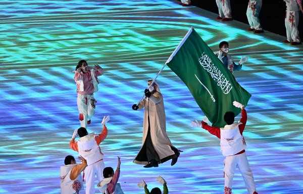 Saudi Arabia's flag bearer Fayik Abdi leads his delegation during the opening ceremony of the Beijing 2022 Winter Olympic Games in Beijing on February 4. [Pierre-Philippe Marcou/AFP]
