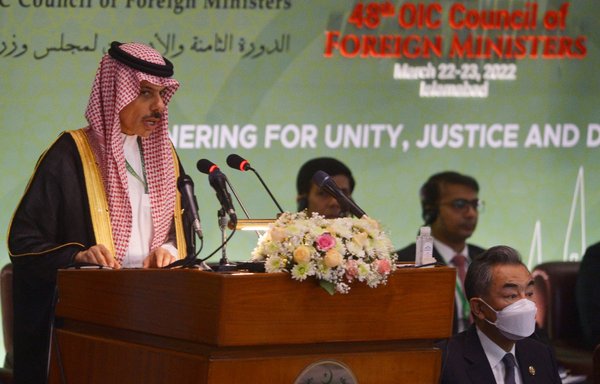 Saudi Arabia's Minister of Foreign Affairs Prince Faisal bin Farhan Al Saud speaks next to Chinese Foreign minister Wang Yi (R) during the 48th session of the Organisation of Islamic Co-operation Council of Foreign Ministers, in Islamabad on March 22. [Farooq Naeem/AFP]