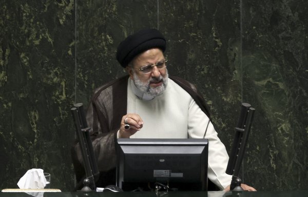 Iranian President Ebrahim Raisi speaks during a parliament session in Tehran on October 4. [Atta Kenare/AFP]
