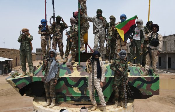 Fighters for The National Movement for the Liberation of Azawad (MNLA), one of Mali's main armed groups, pose for a picture on August 28. [Souleymane Ag Anara/AFP]