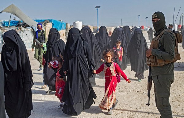 Women and children are seen inside al-Hol camp in Syria's al-Hasakeh province during an August 26 security operation by the Asayesh (Kurdish internal security forces) and the Syrian Democratic Forces. [Delil Souleiman/AFP]