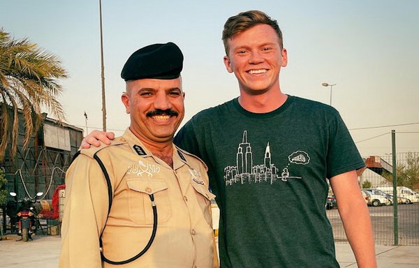 Vlogger Doug Barnard poses with an Iraqi security officer during his visit to Iraq, which he documented with photos and videos about the country's landmarks and shared with thousands of followers. [Doug Barnard's Instagram account]