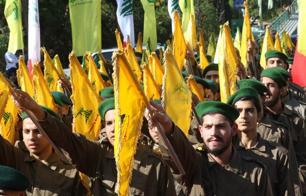 Fighters from Lebanese Hizbullah take part in a military parade marking the group's Martyrs' Day in Ghazieh, south of Sidon, on November 12, 2019. [Mahmoud Zayyat/AFP]