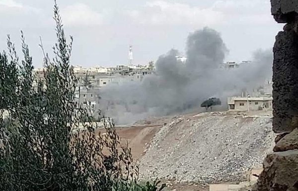 Smoke rises from homes that caught fire during fighting between ISIS and local factions in the southern Syrian city of Daraa on October 31. [Horan Free League]