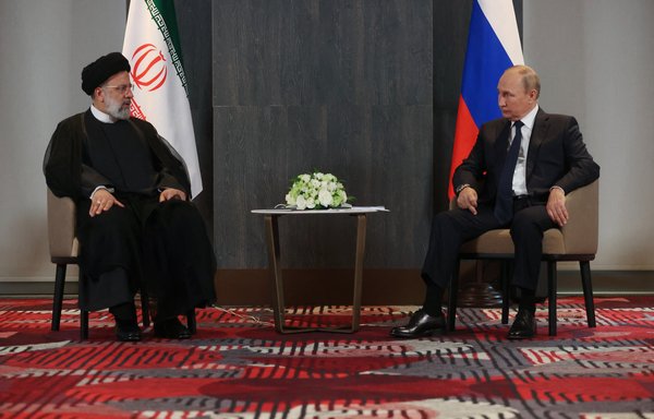 Russian President Vladimir Putin meets with his Iranian counterpart Ebrahim Raisi on the sidelines of the Shanghai Co-operation Organisation leaders' summit in Samarkand on September 15. [Alexandr Demyanchuk/Sputnik/AFP]
