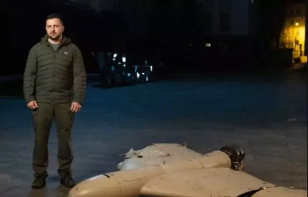 Ukrainian president Volodymyr Zelenskyy stands next to the remnants of an Iranian drone on October 28. [President.gov.ua]